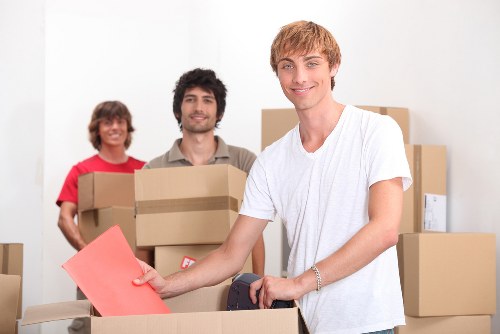 Commercial removals team transporting desks and boxes through central London